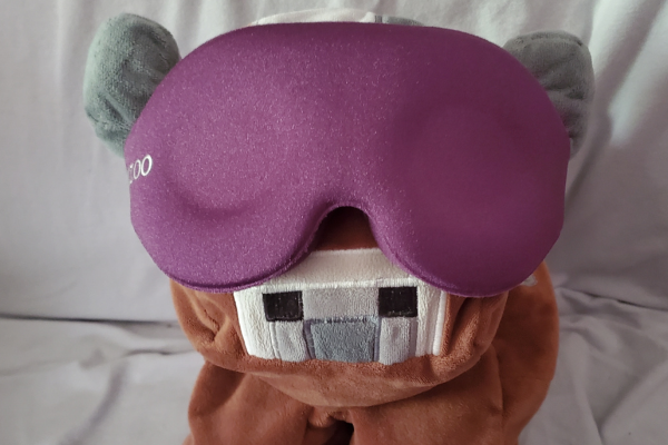 Henry wearing a purple sleep shade over his eyes.